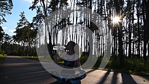 Healthy lifestyle. Woman drink water in lotus pose on natute background. Forest, sun rays trees. Drink pure water on