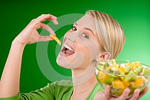 Healthy lifestyle - woman eat slice of orange