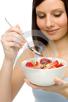 Healthy lifestyle - woman eat strawberry cereal