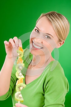 Healthy lifestyle - woman eating kiwi and orange
