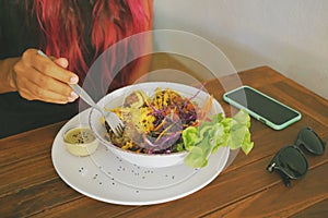 Healthy Lifestyle Woman Eating Vegan Falafel Balls with Fresh Green Salad in Vegetarian Restaurant.