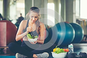 Healthy lifestyle woman fitness gym for body slim. Young people girl hold fresh salad after exercise. Fitness instructor exercisin