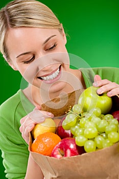 Healthy lifestyle - woman with fruit in paper bag