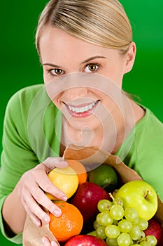 Healthy lifestyle - woman with fruit in paper bag