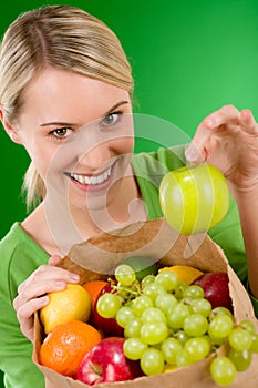 Healthy lifestyle - woman with fruit in paper bag