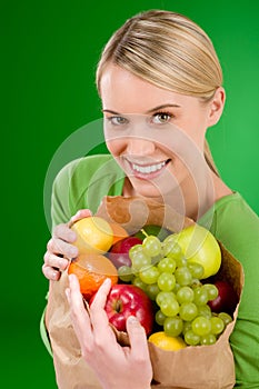 Healthy lifestyle - woman with fruit in paper bag