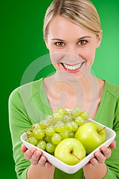 Healthy lifestyle - woman holding bowl with fruit