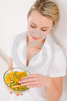 Healthy lifestyle - woman holding fruit salad