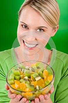 Healthy lifestyle - woman holding fruit salad bowl