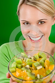 Healthy lifestyle - woman holding fruit salad bowl