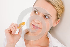 Healthy lifestyle - woman holding tangerine slice