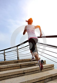 Healthy lifestyle woman legs running on stone stai