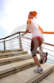 Healthy lifestyle woman legs running on stone stai