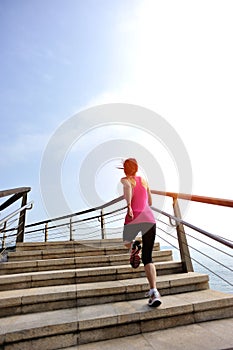 Healthy lifestyle woman legs running on stone stai