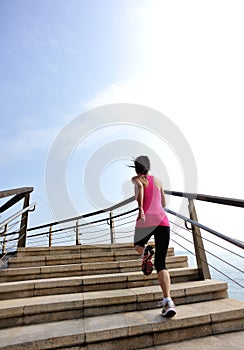 Healthy lifestyle woman legs running on stone stai