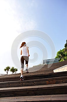 Healthy lifestyle woman legs running on wooden sta