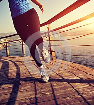 Healthy lifestyle woman runner running seaside