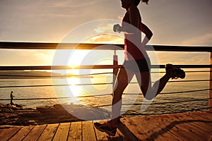 Healthy lifestyle woman runner running seaside