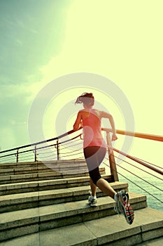 Healthy lifestyle woman running on stone stairs