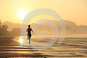 Healthy lifestyle woman running at sunrise beach