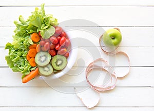 Healthy lifestyle for women diet with measuring tape, vegetable fresh, green apples on white wooden.