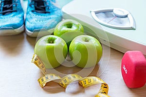 Healthy lifestyle for women diet with sport equipment, sneakers, measuring tape,