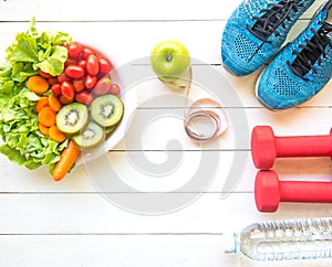 Healthy lifestyle for women diet with sport equipment, sneakers, measuring tape, vegetable fresh, green apples and bottle of water