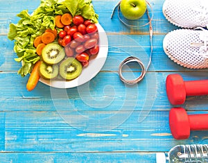 Healthy lifestyle for women diet with sport equipment, sneakers, measuring tape, vegetable fresh, green apples and bottle of water