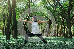 Healthy lifestyle for women practicing meditation and yoga in the forest. Young woman practicing yoga outdoors. Meditation concept