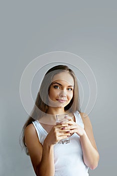 Healthy lifestyle.Young woman drinking from a glass of fresh water. Healthcare. Drinks.