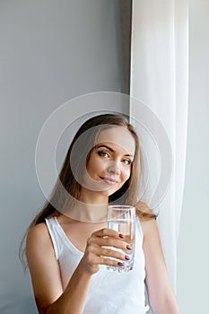Healthy lifestyle.Young woman drinking from a glass of fresh water. Healthcare. Drinks.