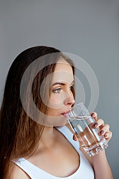 Healthy lifestyle.Young woman drinking from a glass of fresh water. Healthcare. Drinks.