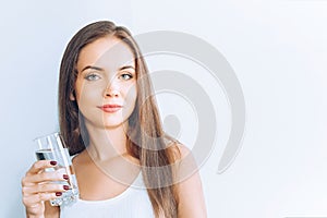 Healthy lifestyle.Young woman drinking from a glass of  fresh water. Healthcare. Drinks. Portrait of happy smiling female model ho