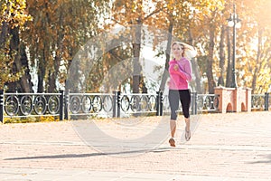 Healthy Lifestyle. Young woman jogging outdoors autumn season motion looking forward motivated