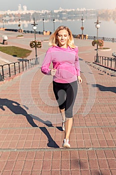 Healthy Lifestyle. Young woman jogging up the stairs on the street autumn season closed eyes joyful