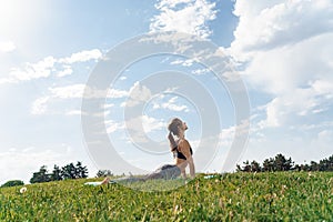 Healthy Lifestyle. Young woman outdoors doing yoga cobra pose on mat closed eyes relaxed