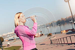 Healthy Lifestyle. Young woman standing outdoors autumn season drinking water closed eyes smiling joyful