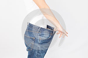 Healthy lifestyles concept Weight loss woman with old jeans healthcare, diet and fitness