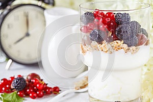 Healthy light breakfast: parfait with muesli, berries and yogurt