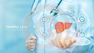 Healthy Liver. Cirrhosis and hepatitis treatment medical concept. Doctor holding in hand the hologram of Human liver and medicine