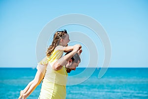 Healthy loving father and daughter playing together at the sea beach. Happy fun smiling lifestyle. Family vacation at