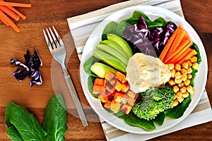 Healthy lunch bowl with avocado, hummus and vegetables