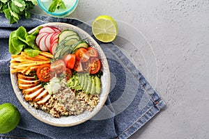 Healthy lunch bowl with chicken, fresh vegetables and quinoa