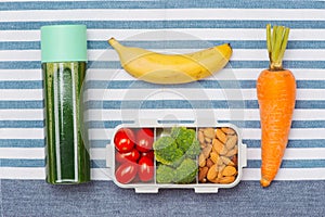 Healthy lunch box with sandwich and fresh vegetables, bottle of