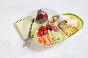 Healthy lunch box with sandwich and fresh vegetables, fruits, bottle of water and juice. from top view