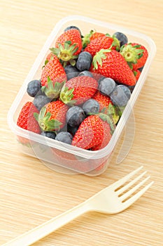 Healthy lunch box with strawberry and blueberry mix