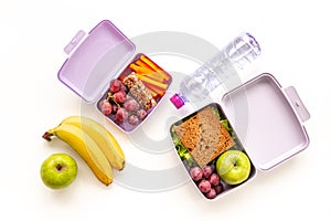 Healthy lunch boxes filled with fruits and vegetables, top view