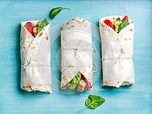 Healthy lunch snack. Tortilla wraps with grilled chicken fillet and fresh vegetables