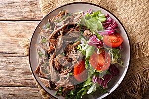 Healthy lunch: tender beef with vegetable salad close-up on a pl