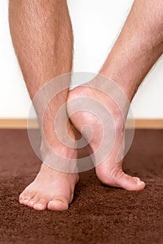 Healthy male feet with towel stepping